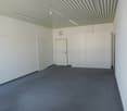 empty room, grey carpet, white walls, gray ceiling, ceiling lights, white closets, entrance door, interior door