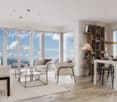 Large glass windows, chandelier, glass table, comfy chairs, dining area, wooden floor, shelf with books