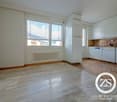 Empty room with white walls, marble floor, window with shutters, built-in white refrigerator and dishwasher