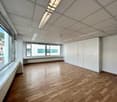 Empty room, large windows, white walls, white ceiling, wooden floor, built-in white cabinets