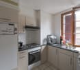 white cabinets, stove, sink, fridge, countertop, window, ventilation