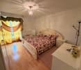 king-size bed, crib, carpet, floor lamp, white cabinets, yellow curtains