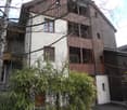multistory building, wooden exterior, balcony, window, shrubs