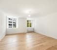 empty room, hardwood floor, two windows, white walls, ceiling lamp, radiator