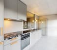 modern white kitchen, granite countertop, stainless steel appliances, wooden handles, gas range