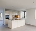 modern kitchen, large windows, large island, built-in appliances, tiled floor
