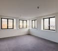 empty room, large windows, tiled floor, city view