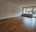 empty room, wooden floor, sliding glass door, balcony, white walls, white ceiling, white radiator