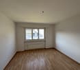 empty room, wooden floor, white walls, window, radiator