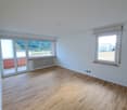 empty room, wooden floor, sliding glass doors, windows, balcony, white walls, white ceiling, white radiator