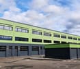 Green and grey exterior, multiple windows, garage doors, driveway