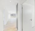 light wood floor, white walls, open door, balcony, large windows
