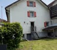 2 story house, white brick, red shutters, stairs, garage