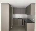 modern kitchen with gray cabinets, black countertops, stainless steel sink, dishwasher, and tiled floor