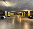spacious underground parking with yellow pillars and lighting