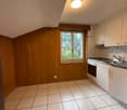 empty kitchen with white tiles, wooden walls, window, sink, oven, refrigerator