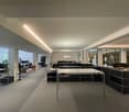 large open space with desks and chairs, modern and clean, multiple large windows