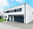 modern, white exterior, black and gray accents, large driveway, large garage