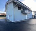 2 story blue house, 3 garages, balcony on second floor, drainpipe