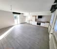 empty room, white walls, gray tiles, kitchen with oven and sink, windows, sliding door