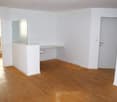 empty room, white walls, white countertop, wooden floor, glass partition, doors