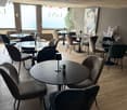 round tables and chairs, lamps, flowers, gray walls, picture