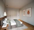 Bedroom with bed, nightstand, rug, and two framed pictures on the wall