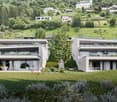 Modern two-story house, white exterior, large windows, terrace, surrounded by greenery