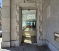 Exterior stone wall, central entrance, modern design, decorative stonework, polished floors, stairs