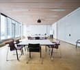 conference room, rectangular layout, white walls, wooden floor, glass windows, projector, rectangular table, chairs, whiteboard