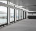 large windows with a view to the lake, wooden floor, white walls