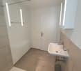 Bathroom with glass shower, sink, and a bathtub