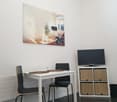 dining area with a table, chairs, cabinet, TV and radiators