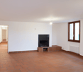 empty room, fireplace, white walls, red tile floor, radiator