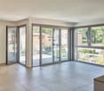 large sliding glass doors, balcony, tiled floor, large windows, view of garden
