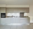 modern kitchen with stainless steel countertops, built-in oven, sink, and dishwasher