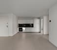 The image shows a modern, open-plan apartment with a kitchen and living area. The apartment has white walls, gray tile flooring, and a minimalist white kitchen with built-in appliances. The space appears to be newly renovated and has a clean, minimalist a