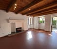 wooden ceiling, brown floor, fireplace, 3 windows, doors