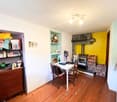 Fireplace, shelves, white desk with chairs, wooden cabinet with drawers