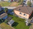 2 story house, brown roof, brown garage, small building, garden, green grass