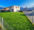 2 story house, white, grey accents, garage, lawn, mountains in the background