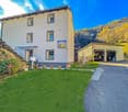 2 story house, white exterior, multiple windows, garage, driveway, garden, mountain view
