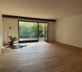 empty room, wooden floor, sliding glass doors, balcony, potted plant, lamp