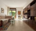 living room with couches, coffee table, carpet, wooden shelves, pictures, terrace