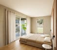Wooden floor, beige walls, large windows, balcony, bed with white pillows, small side table, sliding doors, view of mountains and grassy field, decorative plant on the balcony