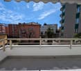 Balcony with metal railings, tiled floor, view of the city and mountains
