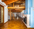 Wooden ceiling, wooden spiral staircase, blue wall, wooden floor, fireplace, spiral staircase