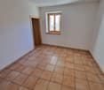 empty room, brown tiles, white walls, wooden window frames, power outlet, open door