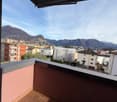 Balcony with tiled floor, view of mountains and city