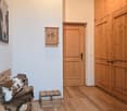 wooden bench with fur pillow, wooden storage box, wooden doors, wooden wall, painting